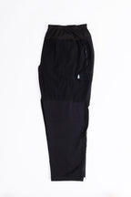 Black hiking pants with a small logo on a white background