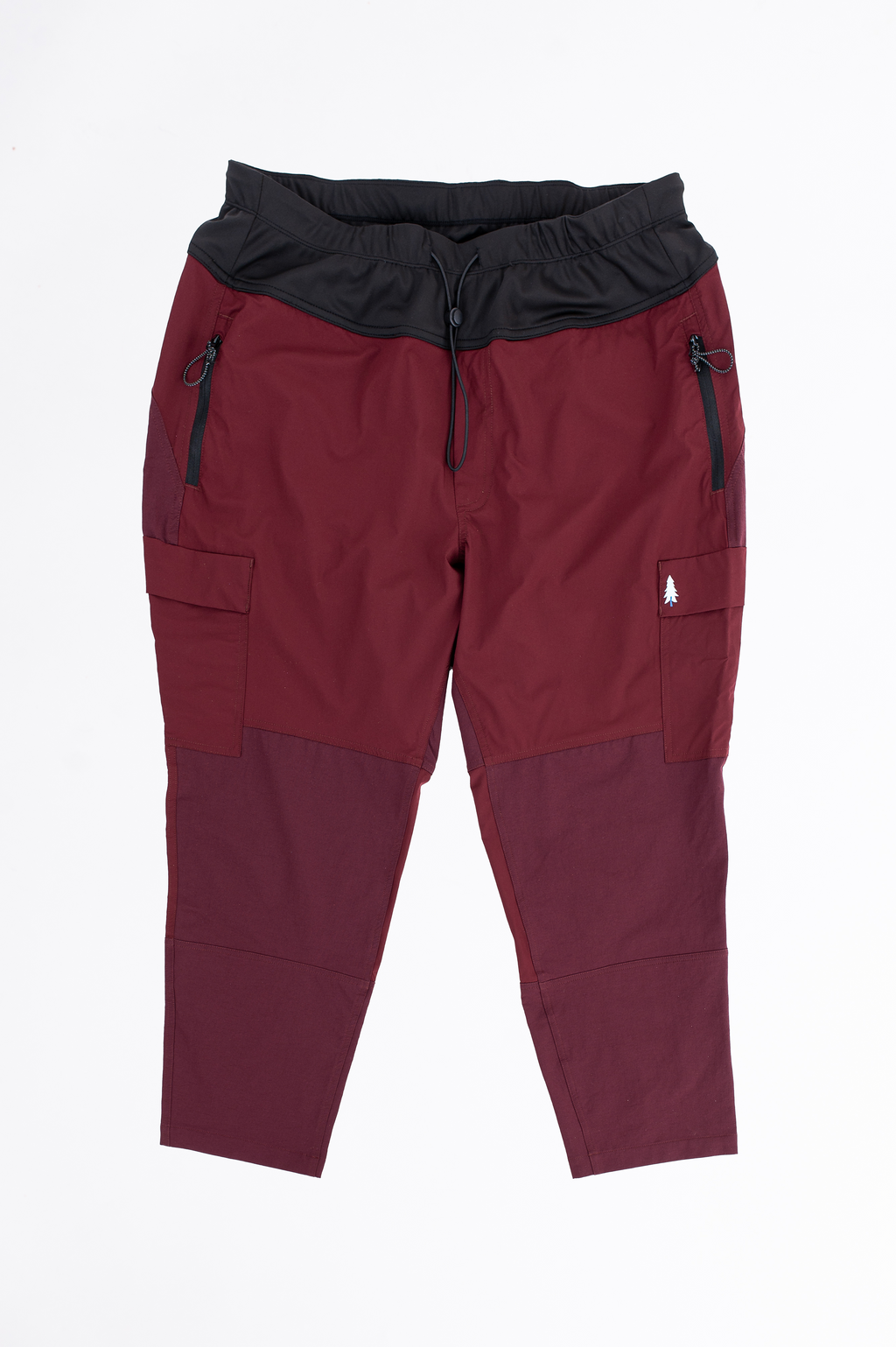 Maroon and black pants with zippers on a white background