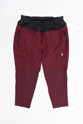 Maroon and black pants with zippers on a white background