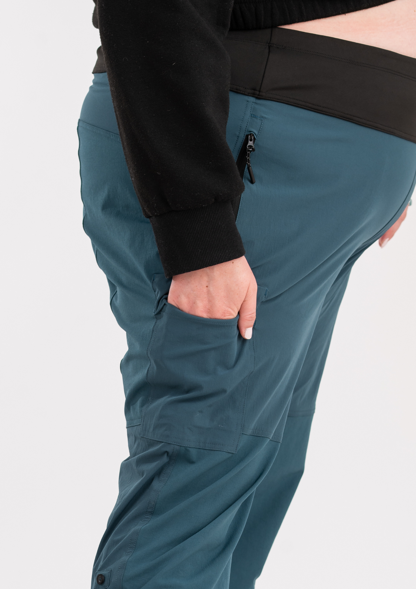 Teal pants with a black jacket on a white background