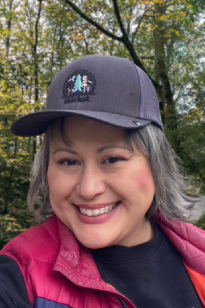 beautiful happy friend wearing the thicket adventure hat.
