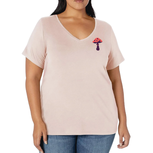 Woman wearing a light pink t-shirt with a small graphic on a white background