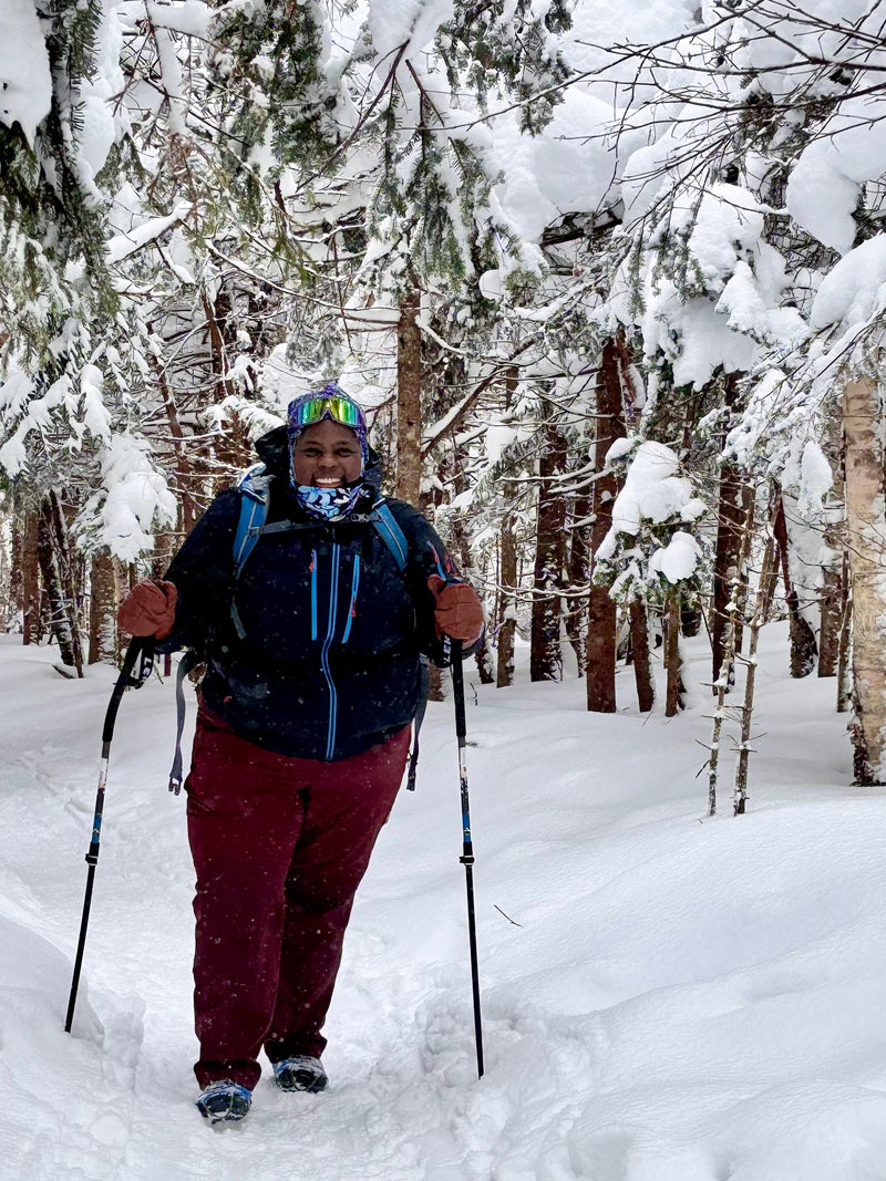 A woman snowshoeing in the woods